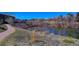 Community pond features lush greenery and a walking path, offering a tranquil escape near the homes at 283 Yank Ct, Lakewood, CO 80228
