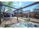 Backyard view featuring a wood fence, table set, detached building and pergola at 4467 W 30Th Ave, Denver, CO 80212
