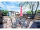 Backyard featuring a metal table set with umbrella, brick patio, and path to the detached building at 4467 W 30Th Ave, Denver, CO 80212