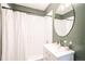 Bathroom with white subway tile, green accents and shower-tub combo at 4467 W 30Th Ave, Denver, CO 80212