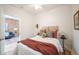 Stylish bedroom with plush bedding, warm accents, and a glimpse into the living space at 4467 W 30Th Ave, Denver, CO 80212