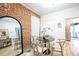 Charming dining area with a modern round table, exposed brick accent wall, and wood floors at 4467 W 30Th Ave, Denver, CO 80212