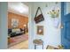 Entryway featuring exposed brick wall and view to living area with blue sofa at 4467 W 30Th Ave, Denver, CO 80212