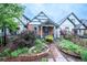 Charming home with colorful landscaping, brick accents, and a covered porch at 4467 W 30Th Ave, Denver, CO 80212