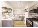 Bright kitchen with stainless steel appliances, gray cabinets, and open shelving at 4467 W 30Th Ave, Denver, CO 80212