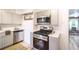 Well-lit kitchen with stainless steel appliances and decorative backsplash at 4467 W 30Th Ave, Denver, CO 80212