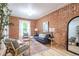 Stylish living room with exposed brick wall, hardwood floors, and elegant decor with large window to the outside at 4467 W 30Th Ave, Denver, CO 80212
