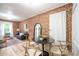 Bright living and dining area with exposed brick, stylish furnishings, hardwood flooring, and natural light at 4467 W 30Th Ave, Denver, CO 80212