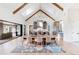 Elegant dining room with a long wooden table and large windows at 6816 Goldbranch Dr, Niwot, CO 80503