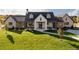 Stunning modern farmhouse exterior with white brick and a spacious lawn at 6816 Goldbranch Dr, Niwot, CO 80503