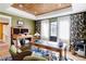 Bright home office features built-in shelving and large windows at 6816 Goldbranch Dr, Niwot, CO 80503