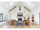 Spacious living room with a fireplace, high ceilings, and leather furniture at 6816 Goldbranch Dr, Niwot, CO 80503