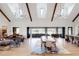 Spacious living room with high ceilings, exposed beams, and large windows at 6816 Goldbranch Dr, Niwot, CO 80503