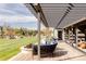Deck with pergola, comfortable seating, fire pit and view of landscaped backyard at 6816 Goldbranch Dr, Niwot, CO 80503