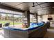 Large covered patio with comfortable seating and fire pit, overlooking backyard at 6816 Goldbranch Dr, Niwot, CO 80503