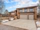 Attractive home featuring a two-car garage, brick accents, and a well-maintained driveway at 16794 W 75Th Pl, Arvada, CO 80007