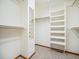 Walk-in closet offering ample storage space with closet organizers and mirror at 16794 W 75Th Pl, Arvada, CO 80007