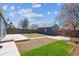 A spacious backyard with a well-kept lawn and a detached garage provides ample outdoor space at 2285 Fulton St, Aurora, CO 80010