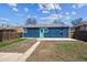 A well-maintained backyard with a blue house and fenced perimeter, perfect for outdoor enjoyment at 2285 Fulton St, Aurora, CO 80010