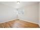 Bright, empty bedroom showcases hardwood floors and natural light through large windows at 2285 Fulton St, Aurora, CO 80010