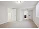 A spacious carpeted bedroom leads to an adjacent bathroom, offering comfort and privacy at 2285 Fulton St, Aurora, CO 80010