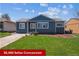 Charming single-story home with a well-maintained lawn and a classic blue exterior at 2285 Fulton St, Aurora, CO 80010