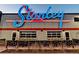 View of building exterior with bright neon sign and stylish facade with windows at 2285 Fulton St, Aurora, CO 80010