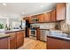 Updated kitchen featuring stainless steel appliances, rich wood cabinetry, and granite counters at 2285 Fulton St, Aurora, CO 80010