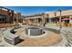 An inviting outdoor mall with a fire pit surrounded by restaurants and shops at 2285 Fulton St, Aurora, CO 80010