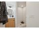 Clean basement bathroom with a shower and wood vanity at 1086 S Pearl St, Denver, CO 80209