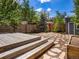 Expansive backyard with wood deck, stone pathway, picnic table, and shed, perfect for outdoor entertaining and leisure at 1423 Elizabeth St, Denver, CO 80206