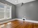 Empty bedroom with hardwood floors and natural light from large, trimmed windows at 1423 Elizabeth St, Denver, CO 80206