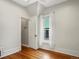 Bedroom features hardwood floors, a closet and bright windows trimmed in white at 1423 Elizabeth St, Denver, CO 80206