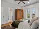 Comfortable bedroom with white trim, hardwood floors, and view into the ensuite bathroom at 1423 Elizabeth St, Denver, CO 80206