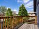 Enjoy outdoor living on this wood deck, complemented by lush trees and blue skies, ideal for relaxation and entertaining at 1423 Elizabeth St, Denver, CO 80206