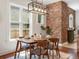 A dining room featuring a modern light fixture and exposed brick wall at 1423 Elizabeth St, Denver, CO 80206