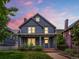 Charming two-story home with a welcoming front porch and manicured lawn, showcasing classic architectural details at 1423 Elizabeth St, Denver, CO 80206