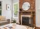 Charming fireplace with a brick surround, wooden mantle, and stylish decor, adding warmth to the living space at 1423 Elizabeth St, Denver, CO 80206