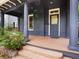 Inviting front porch with classic columns, a cozy swing, and a charming entryway for a warm welcome at 1423 Elizabeth St, Denver, CO 80206