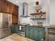 Updated kitchen with stainless steel appliances, wood cabinets and green cabinets at 1423 Elizabeth St, Denver, CO 80206