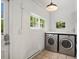 Bright laundry room featuring modern washer and dryer, natural light, and ample counter space for convenient chores at 1423 Elizabeth St, Denver, CO 80206