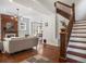 Inviting living room with a cozy fireplace, hardwood floors, and an open staircase, perfect for Gathering gatherings at 1423 Elizabeth St, Denver, CO 80206