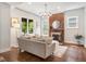 Bright living room featuring hardwood floors, a decorative fireplace with brick accent, and comfortable furnishings at 1423 Elizabeth St, Denver, CO 80206
