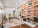 Home office with a stylish glass desk, bookcase, and sitting area at 1423 Elizabeth St, Denver, CO 80206
