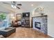 Cozy living room features a fireplace, hardwood floors, and access to a private patio at 8767 E Dry Creek Rd # 1312, Englewood, CO 80112