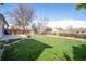 Large, well-maintained backyard featuring lush green grass and a cozy fire pit area at 1838 Cedar St, Broomfield, CO 80020