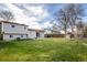 Spacious backyard with a large grassy area and mature trees at 1838 Cedar St, Broomfield, CO 80020