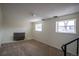 Basement featuring neutral carpet, painted brick accent wall, and two windows allowing plenty of natural light at 1838 Cedar St, Broomfield, CO 80020