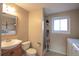Modest bathroom featuring a shower, toilet, sink, and laundry area at 1838 Cedar St, Broomfield, CO 80020