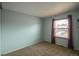 Bedroom features a window with curtains and neutral carpet at 1838 Cedar St, Broomfield, CO 80020